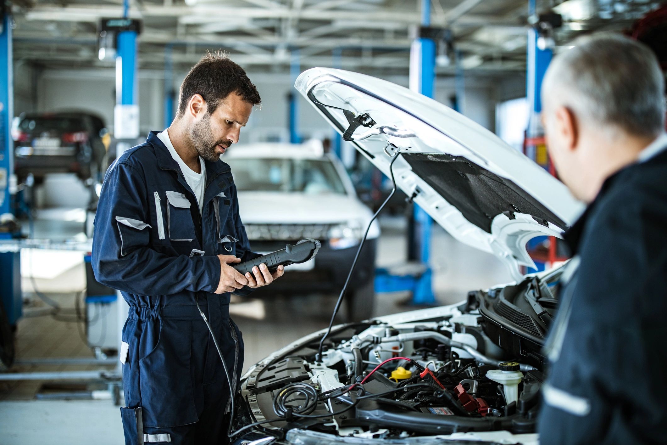 Mechanic using a vehicle diagnostic tool in a repair shop