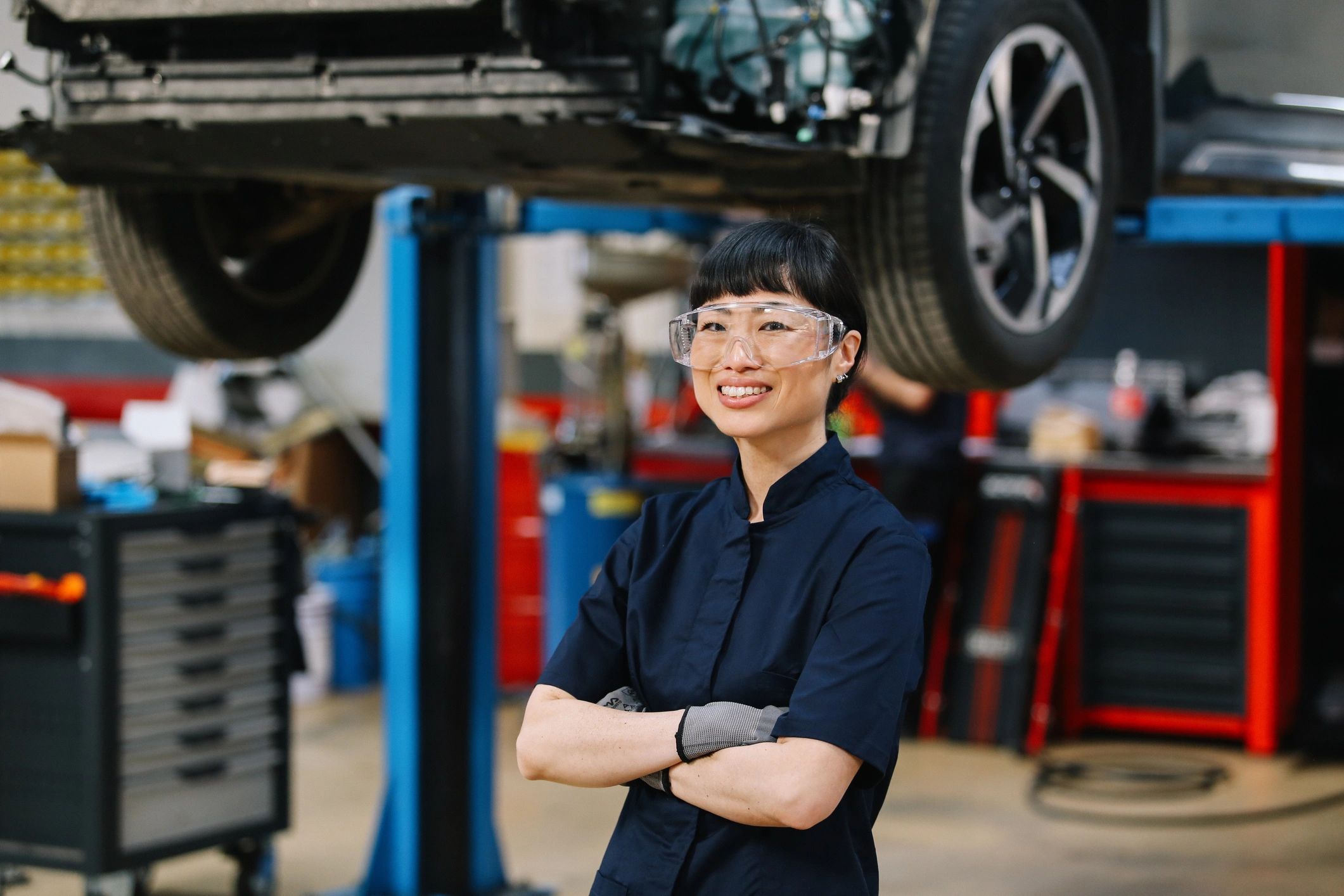 Technician performing a routine vehicle inspection in an auto repair shop