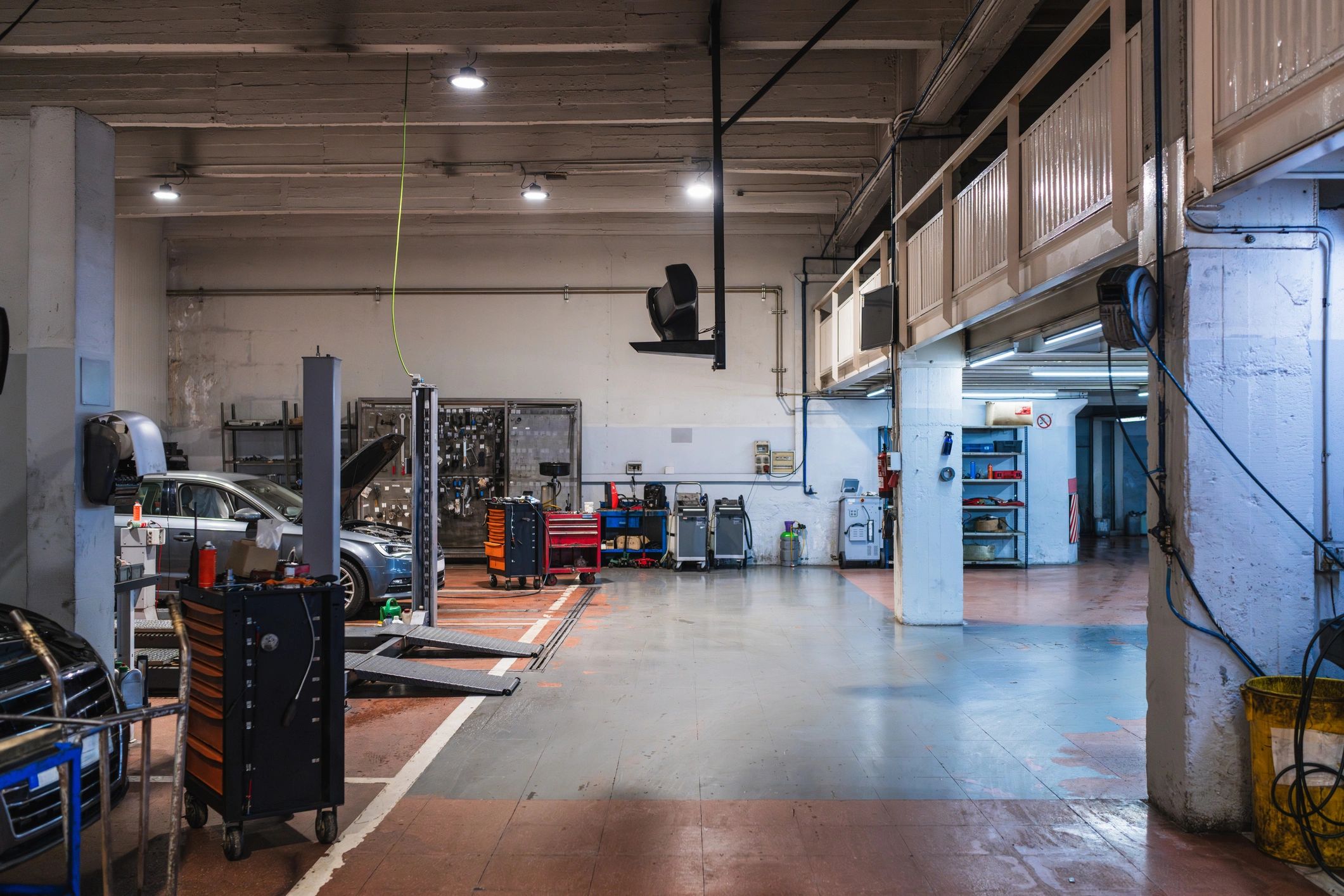 Service bay with vehicle lifts and toolboxes