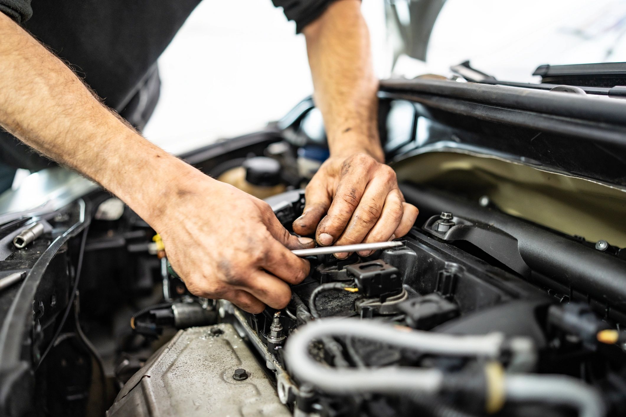 Mechanic servicing an engine in a workshop