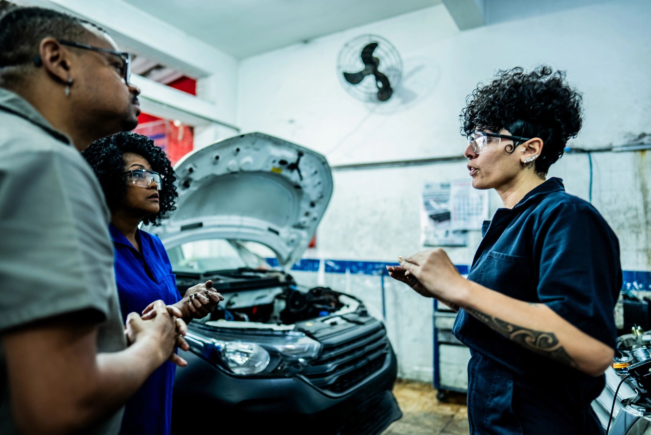 Technicians collaborating in a clean auto repair shop