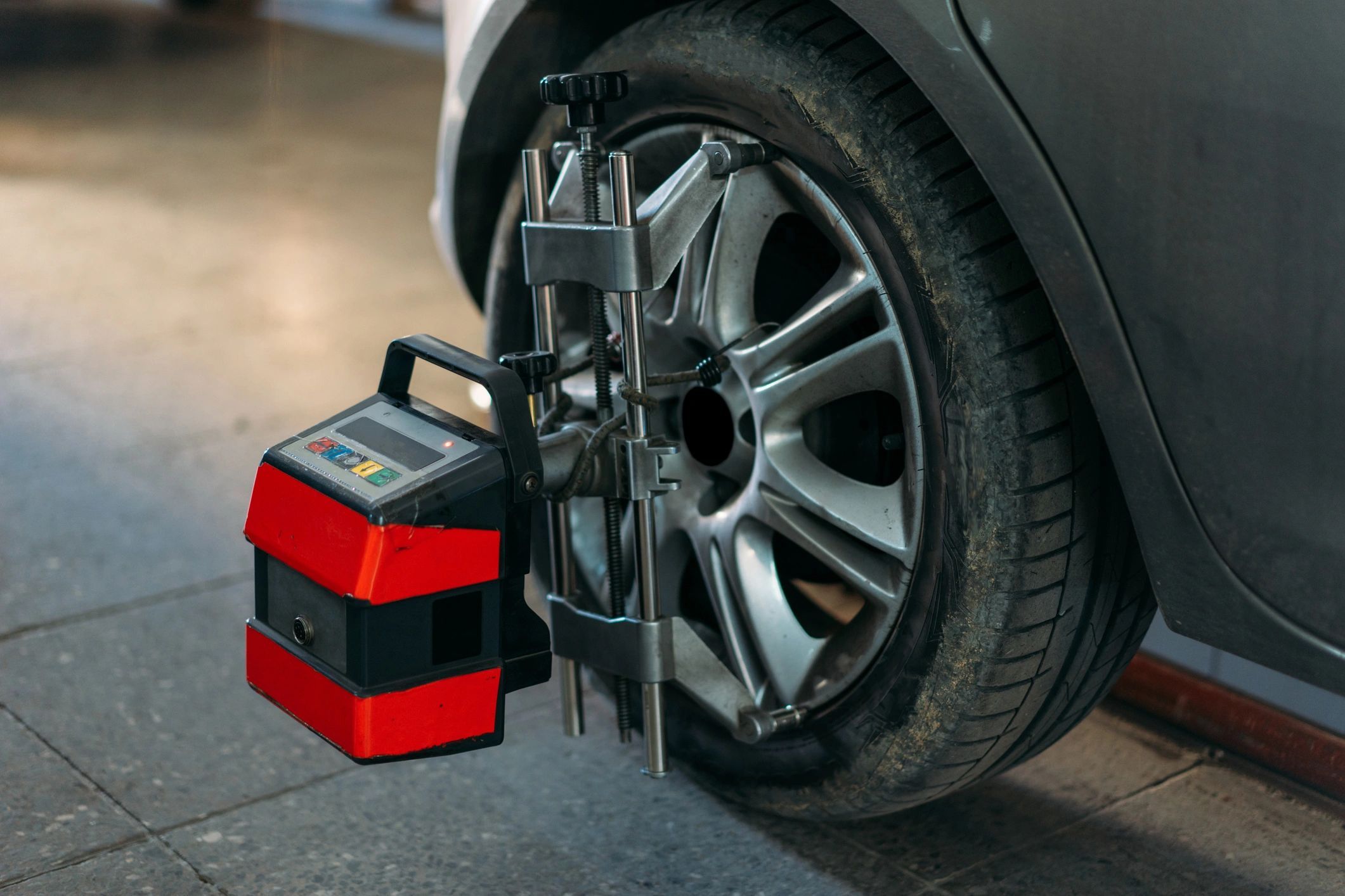 Close-up of a wheel on an alignment machine during service